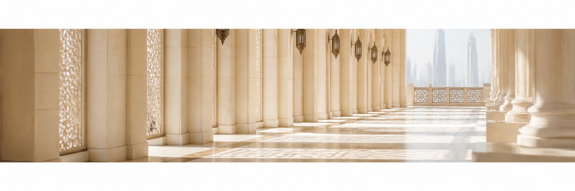 Sunlit cream limestone colonnade with geometric lattice shadows, Dubai
